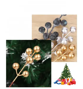 Close-up of gold, silver, and frosted blue artificial berries for Christmas decor