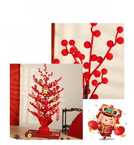 Detail of red berries tree with golden coins and festive charms for Chinese New Year