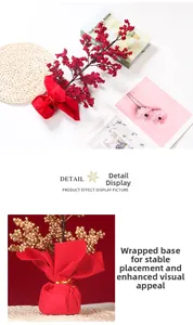 Close-up of artificial red berry stem with a stable red base and gold ribbon detail