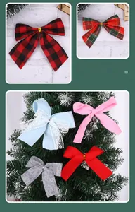Detail of assorted Christmas bows including plaid and velvet styles on a white tree
