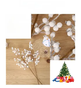 Detail of white artificial Christmas berry branches with realistic snowy texture on wood
