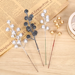 Artificial Christmas berry stems in gold, silver, blue, and white for DIY holiday decor