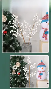 Close-up of white decorative Christmas berry branches in a glass vase with festive decor