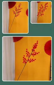 Close-up of lifelike artificial red holly berries and brown stems for Christmas decor