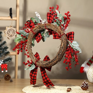 Artificial Christmas wreath with red berries, pine leaves, and buffalo plaid bows decoration