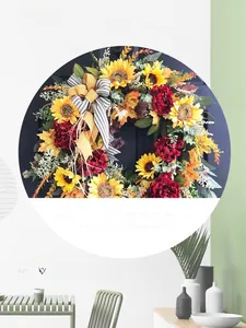 Macro view of sunflower wreath featuring maple leaves and a striped ribbon bow
