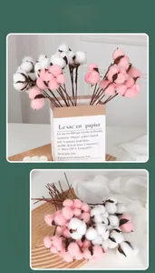 Detail of pink and white artificial cotton stems in a minimalist rustic home decor setting