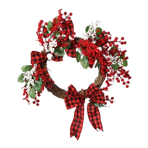 Christmas wreath with red berries green leaves and buffalo plaid bows on vine base