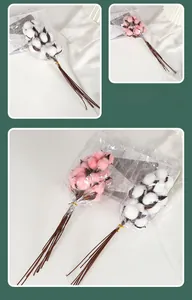 Close-up of artificial white and pink cotton flower bouquet with natural brown dried branches
