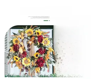 Detailed close-up of decorative sunflower wreath with faux peonies and plaid ribbon bows