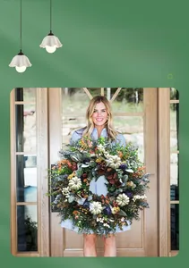Close-up of harvest wreath featuring eucalyptus leaves and white pumpkins on a wooden door