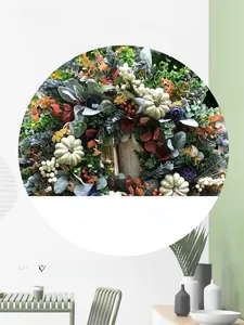 Close-up of fall wreath featuring white pumpkins, purple flowers, and eucalyptus leaves