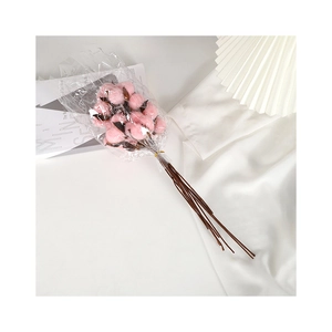 Bouquet of pink dried cotton flowers in transparent packaging for Christmas home decor