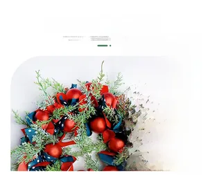 Detail of Nordic Christmas wreath with pine branches, red baubles and ribbons