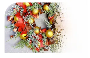 Close-up of Nordic Christmas wreath with red bows, golden balls and Merry Christmas ribbon