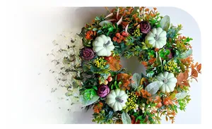 Detail of autumn wreath featuring green pumpkins, purple roses, and fall berries