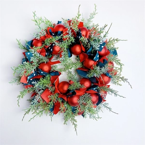 Detail of Nordic Christmas wreath with red ornaments and blue polka dot ribbons