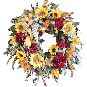 Decorative autumn sunflower wreath with maple leaves and buffalo plaid bow for door decor