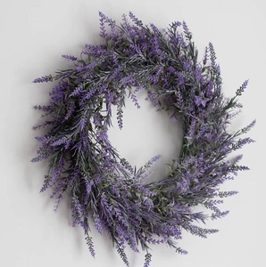Close-up of artificial lavender wreath with purple flower spikes and green leaves