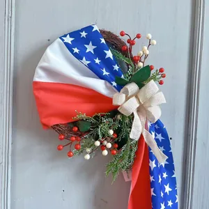 Detail of USA Independence Day wreath with American flag ribbon and burlap bow on wood door