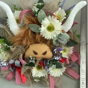 Easter highland cow wreath with daisies and lavender measuring about 40cm on a grey background