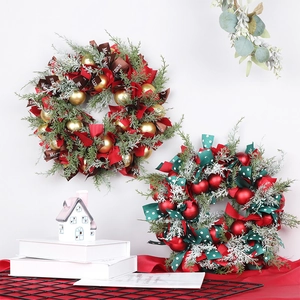 Nordic Christmas wreath featuring red and gold ornaments with festive Merry Christmas ribbons