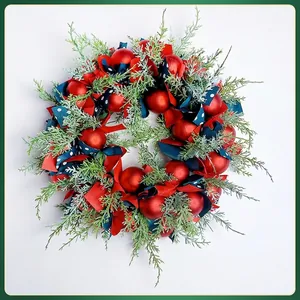Nordic Christmas wreath with red ornaments, green pine branches, and blue ribbon bows