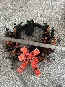 Detailed view of a 45cm Halloween black wreath with a glittery cat and orange web bow
