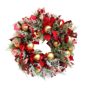 Nordic Christmas wreath with pine needles, red ribbons and matte gold ornaments