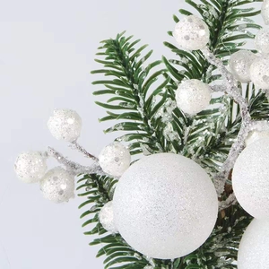 Artificial Christmas wreath with green pine needles and white glitter berries on white background