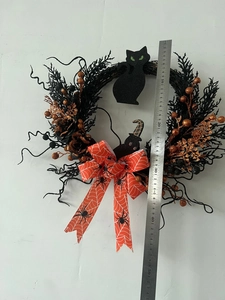 Halloween wreath featuring black cat silhouette and orange bow shown with size ruler