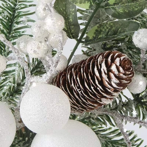 Christmas wreath with green pine needles, frosted pine cones and white glitter berries