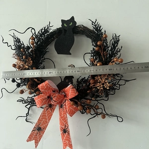 Close-up of Halloween wreath featuring black owl and orange berries measuring 45cm