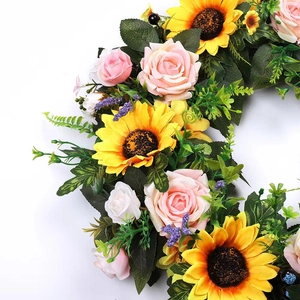 Vibrant sunflower and rose wreath with lush green leaves for spring and summer door decor