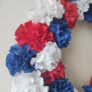 Patriotic red white and blue artificial carnation wreath for American Independence Day decor