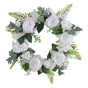 Artificial white rose wreath with lush green leaves and small flowers on white background