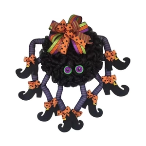 Halloween spider wreath door hanger with orange bow and colorful striped legs in boots