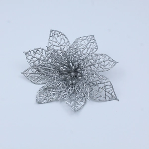 Detailed close-up of a silver glitter artificial flower with hollow petal textures for Christmas