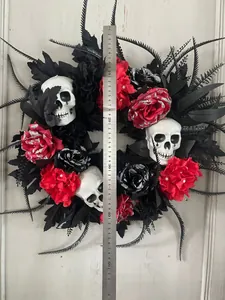Detail view of 50cm Halloween wreath with black leaves, red roses and realistic skulls
