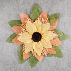 Detailed view of handmade fabric sunflower wreath with orange and yellow petals