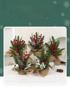 Detail of five mini Christmas trees with red berries and pine cones in burlap bags