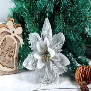 Close-up of silver glitter artificial Christmas poinsettia with golden center detail