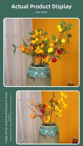 Artificial fruit branches with lemon and pomegranate in a ceramic vase for home decor