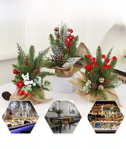 Miniature Christmas cedar tree with red berries and pinecones in a rustic burlap base