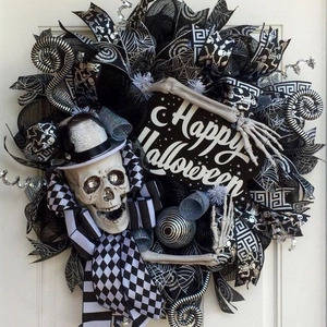 Close-up of Halloween wreath with skull, top hat and Happy Halloween signage details