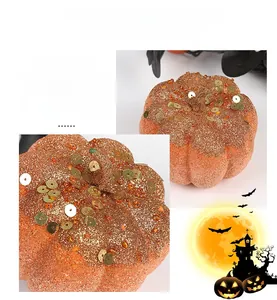 Close-up of glittery orange Halloween pumpkin with gold sequins and textured bead details