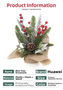 Detail of mini Christmas tree featuring pine needles, red berries, and rustic burlap base