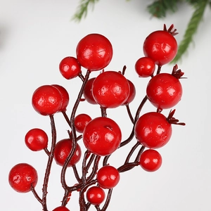 Artificial red Christmas berries with glossy finish on brown stems for holiday home decor
