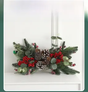 Detail of Christmas artificial greenery garland with pine cones and red berries