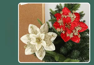 Detail of red and cream artificial Christmas poinsettia flowers with gold glitter accents